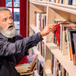 Panic Ensues as Mysterious Visitor Prompts Frantic Disappearance of Beloved Novels at Local Bookshop