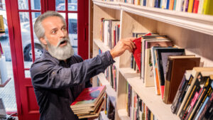 Panic Ensues as Mysterious Visitor Prompts Frantic Disappearance of Beloved Novels at Local Bookshop